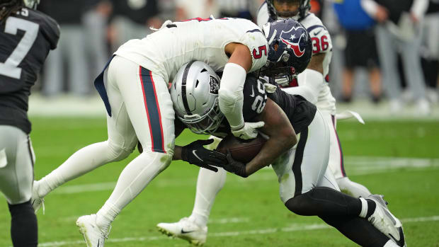 Oct 23, 2022; Paradise, Nevada, USA; Las Vegas Raiders running back Josh Jacobs (28) runs into Houston Texans safety Jalen Pitre (5) in the first half at Allegiant Stadium. Mandatory Credit: Stephen R. Sylvanie-USA TODAY Sports